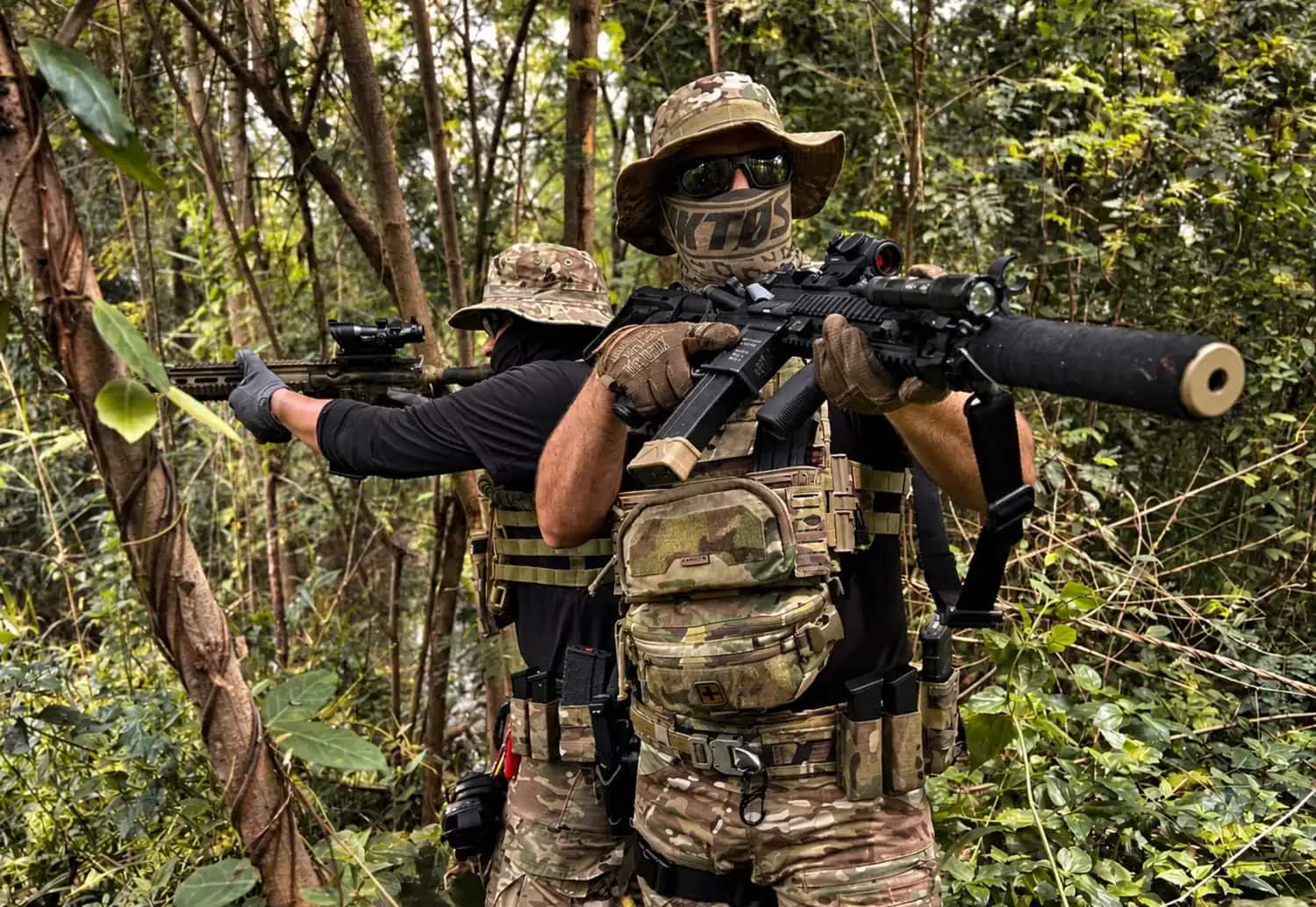 A two-man element moving through close country on a field exercise