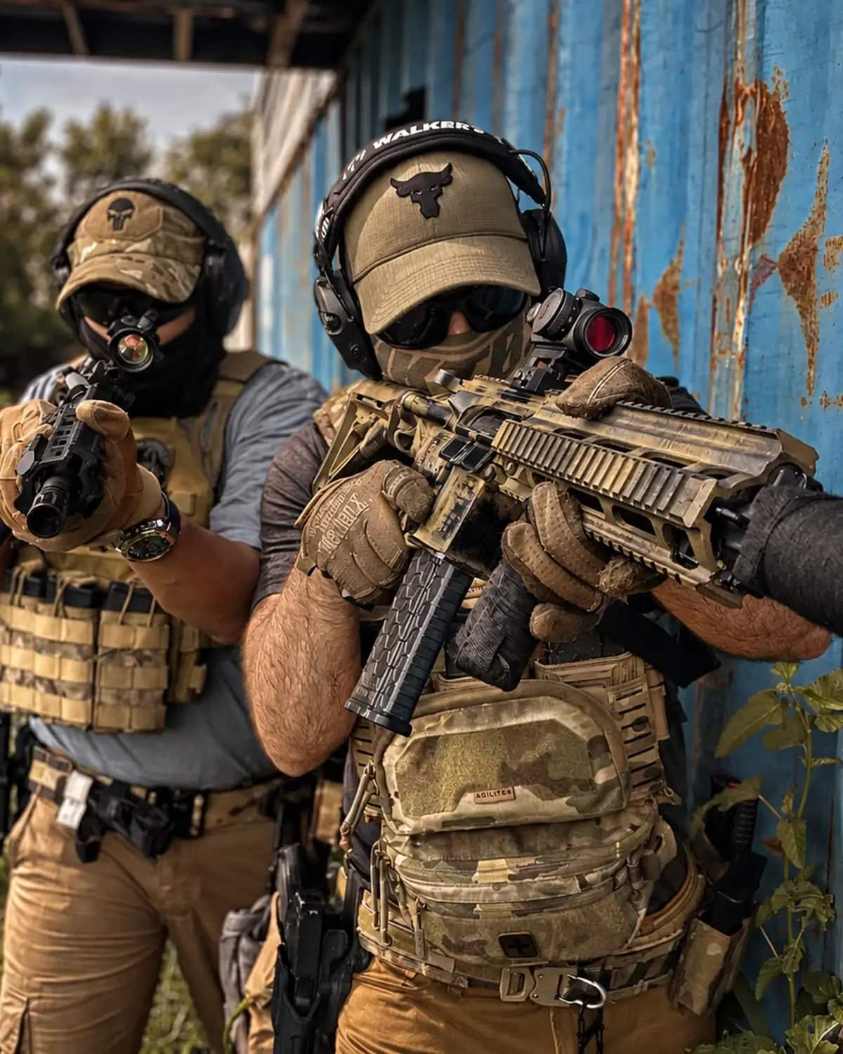Two Unit 21 Group operators covering an angle with carbines during a structured training serial